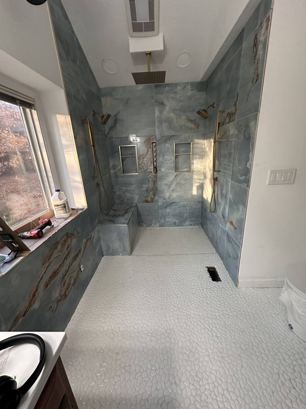 Wide view of custom tiled walk-in shower remodel